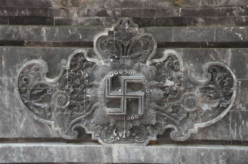 Swastika symbol at Goa Lawah Hindu temple entrance in Bali, Indonesia