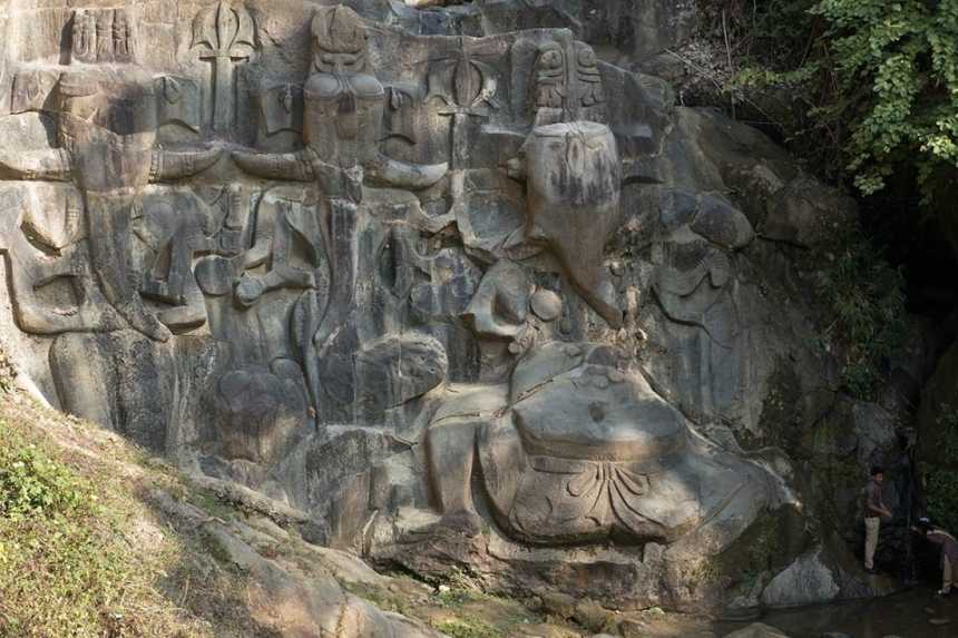 The Mysterious Stone Carvings In Unakoti 4 The gigantic sculptures of Ganesha and other mythological figures in the green hills of Unakoti at the archaeological site in the state of Tripura in Northeast India.