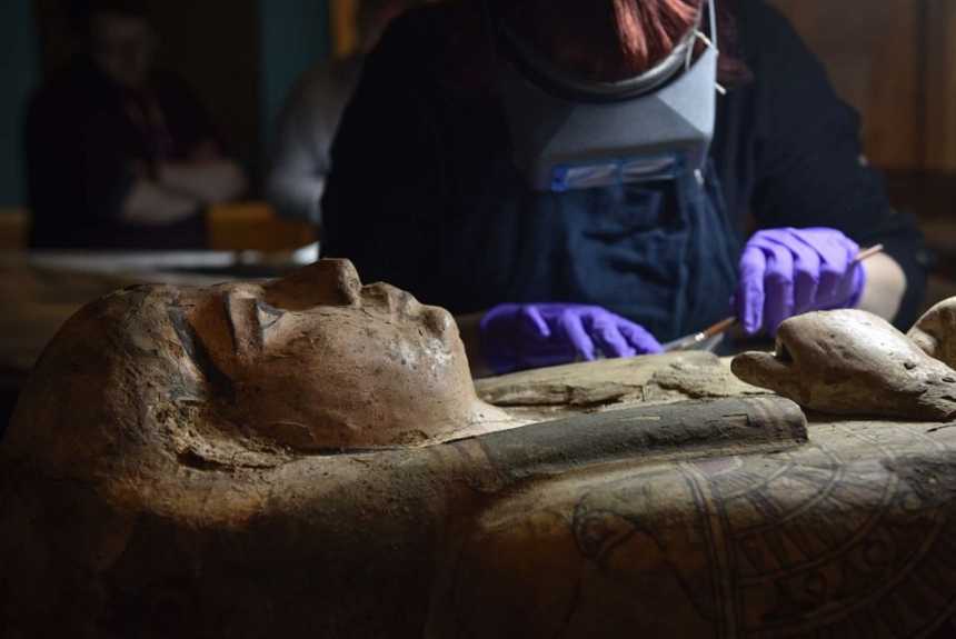 Conservators at Perth Museum and Gallery cleaning the 3,000 old mummy Ta-Kr-Hb's coffin.