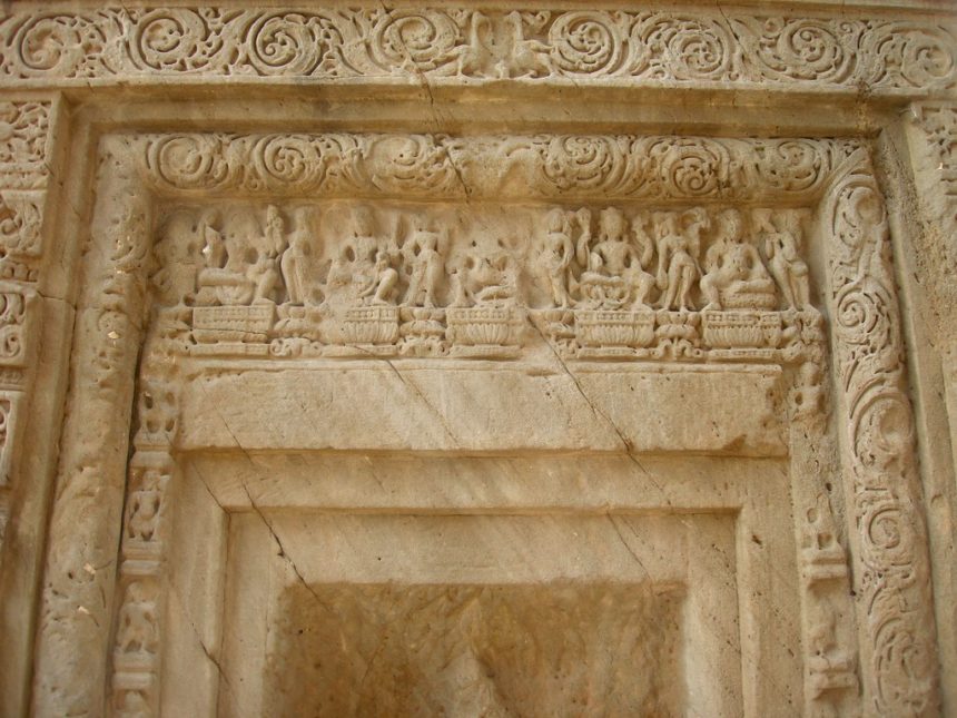 The Masrur temple is adorned with detailed carvings of figures and floral patterns.